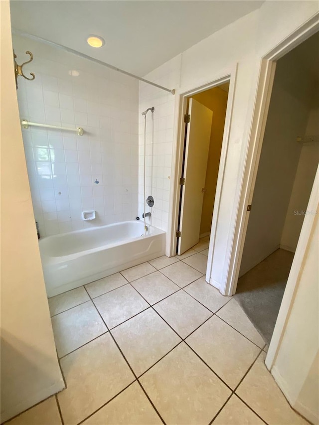 bathroom with tile patterned floors and tiled shower / bath