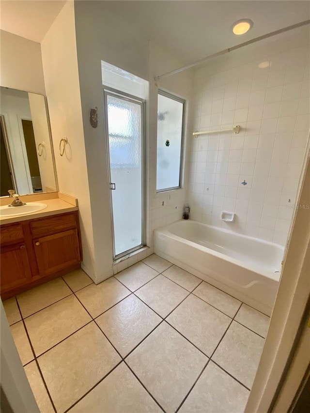 bathroom featuring tiled shower / bath, vanity, and tile patterned floors