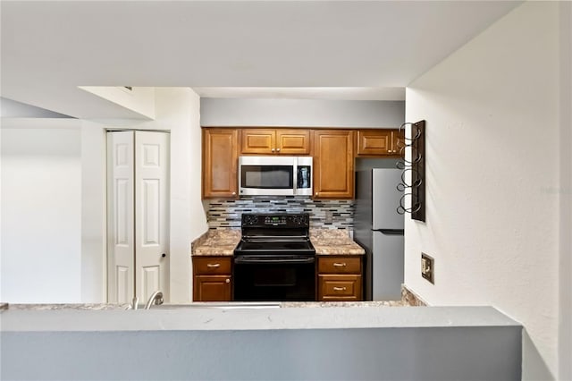 kitchen with stainless steel appliances and decorative backsplash