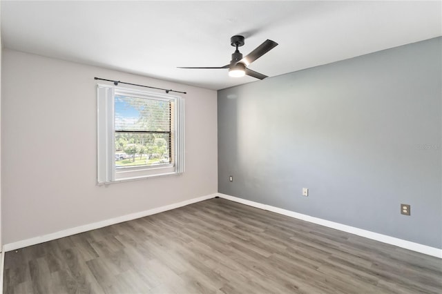 empty room with ceiling fan and wood-type flooring