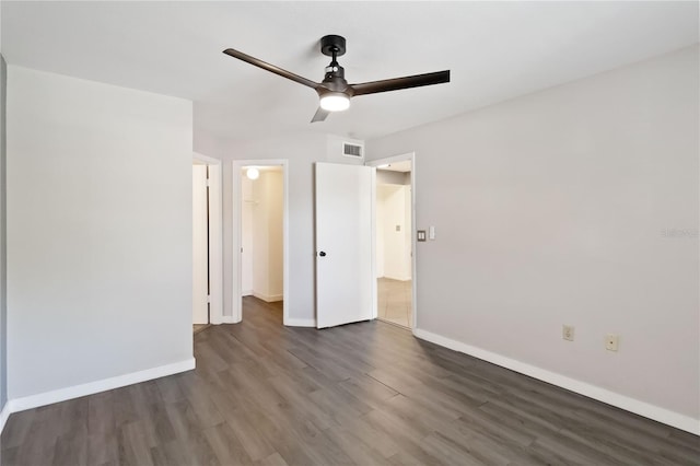 unfurnished bedroom with dark hardwood / wood-style flooring and ceiling fan