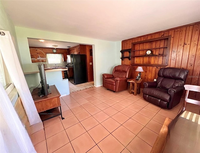 tiled living room featuring wooden walls