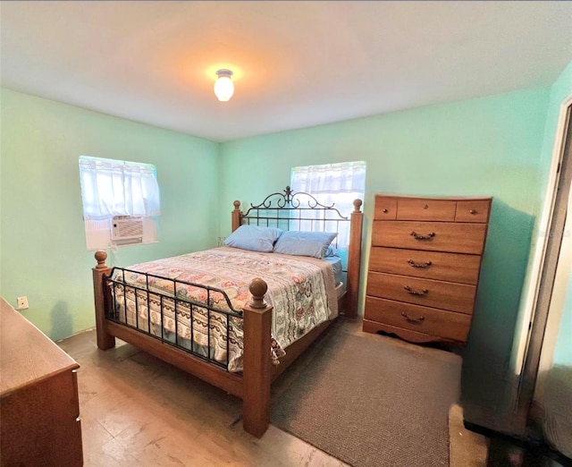 bedroom featuring multiple windows, cooling unit, and tile patterned floors