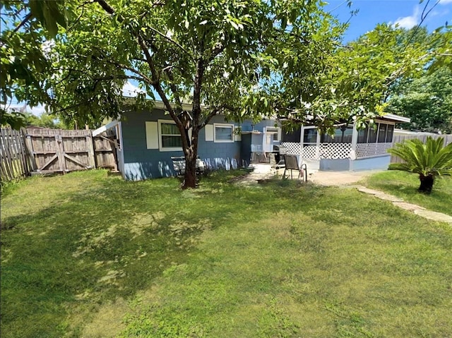 rear view of property featuring a lawn