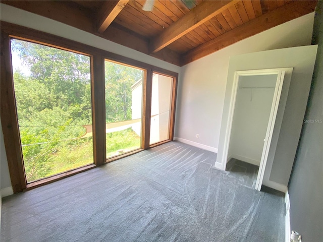 unfurnished bedroom featuring carpet, vaulted ceiling with beams, and wooden ceiling