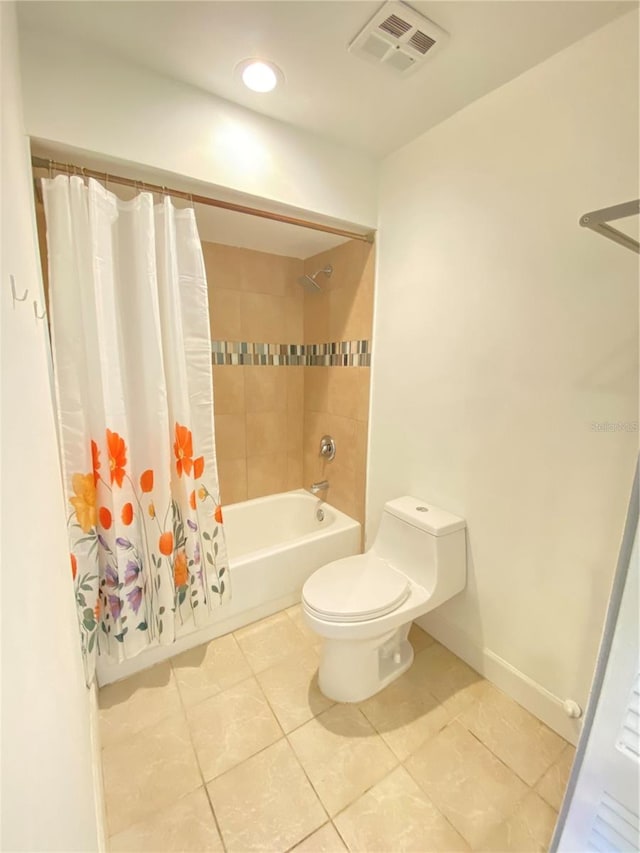 bathroom featuring tile patterned floors, shower / tub combo with curtain, and toilet