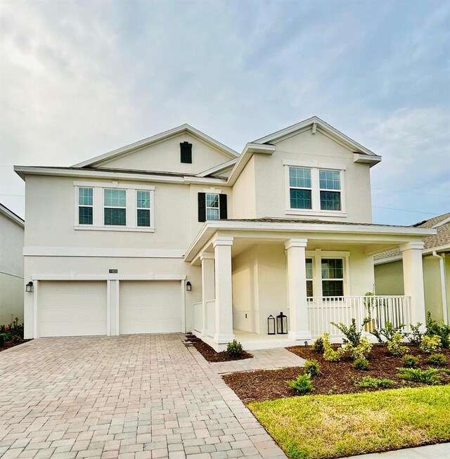 view of front of house featuring a garage and a porch