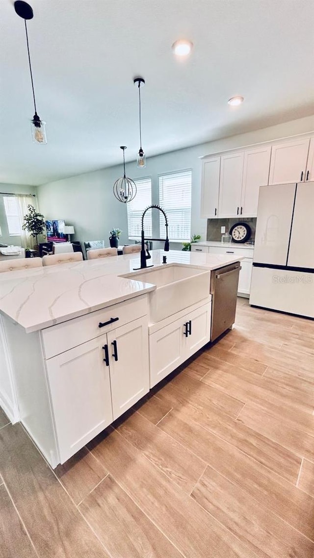 kitchen featuring light wood-type flooring, white cabinets, white fridge, and dishwasher