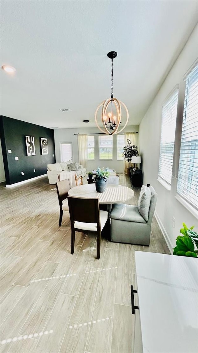 interior space with light hardwood / wood-style floors and a chandelier