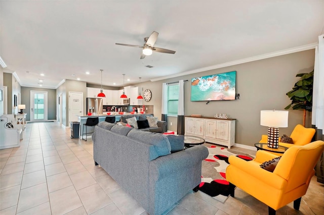 tiled living room with ornamental molding, sink, and ceiling fan