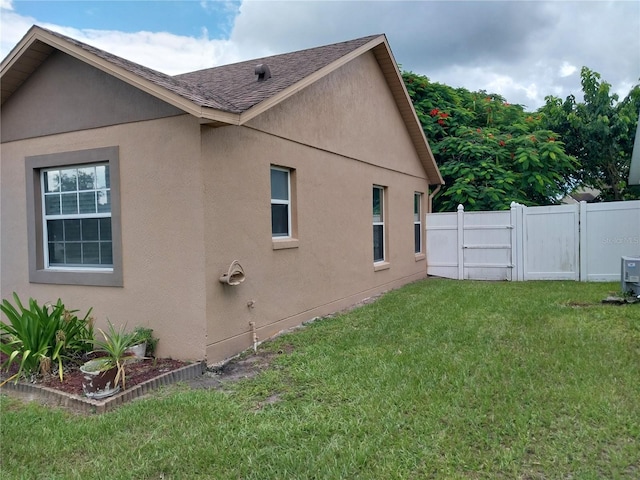 view of side of property with a lawn