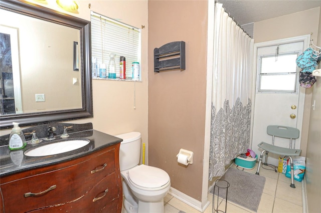 bathroom with tile patterned floors, vanity, and toilet