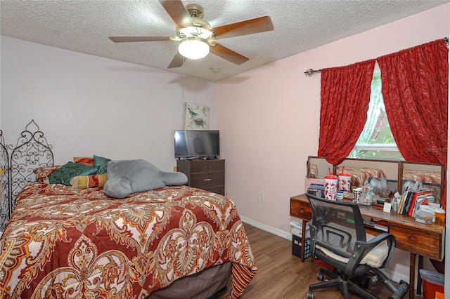 bedroom featuring wood-type flooring, a textured ceiling, and ceiling fan