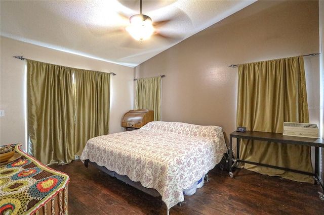 bedroom featuring a textured ceiling, ceiling fan, dark hardwood / wood-style flooring, and vaulted ceiling