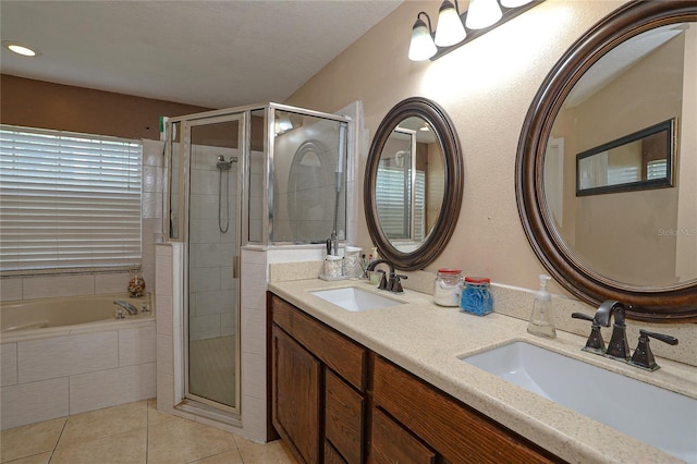 bathroom featuring tile patterned floors, vanity, and shower with separate bathtub