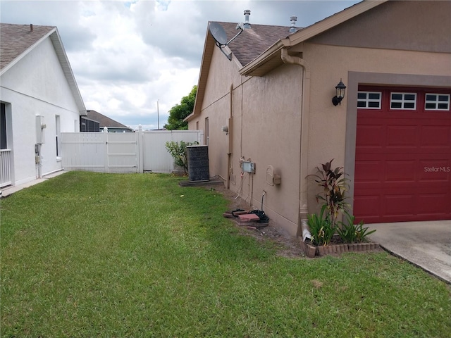 view of side of property with cooling unit and a lawn