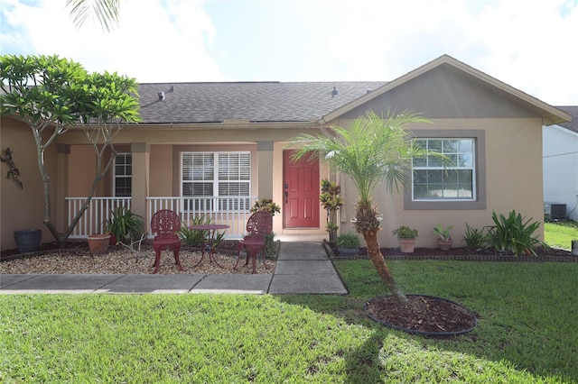 ranch-style house featuring central AC, a front lawn, and covered porch