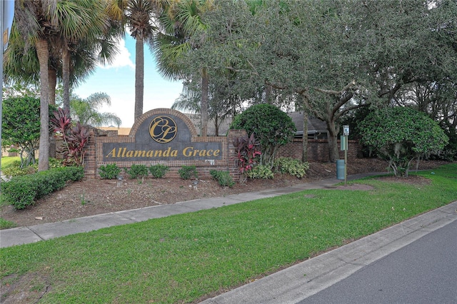 community sign featuring a lawn