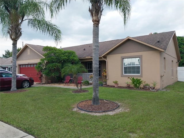 single story home with a porch, a garage, and a front yard