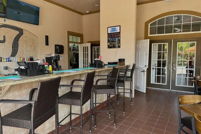 view of patio with french doors and a bar