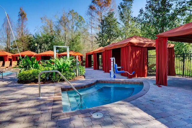 pool featuring a gazebo, a patio area, and fence