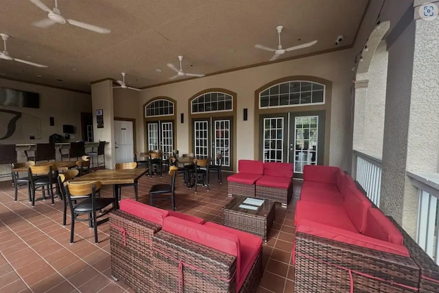 view of patio featuring an outdoor living space, a ceiling fan, and french doors