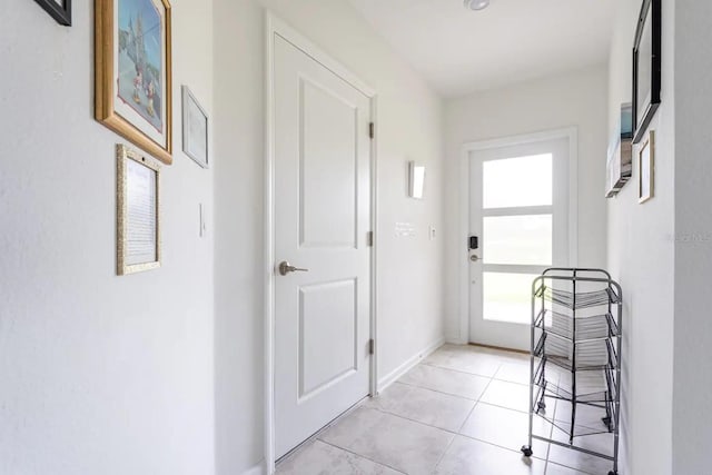 doorway to outside with light tile patterned floors and plenty of natural light