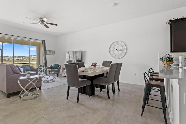 tiled dining room with ceiling fan