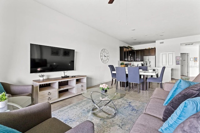 tiled living room with ceiling fan