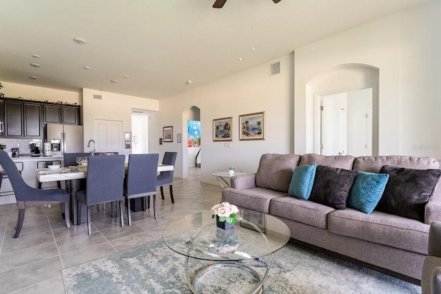 tiled living room with ceiling fan