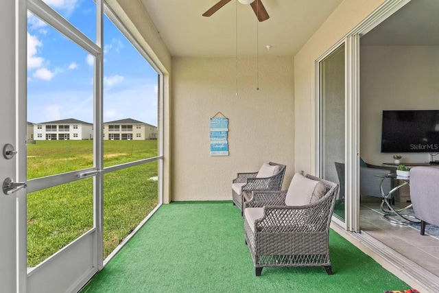 sunroom / solarium with a wealth of natural light and ceiling fan