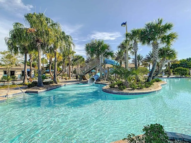 view of swimming pool with a water slide