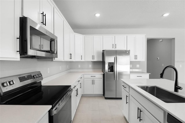 kitchen featuring white cabinetry, appliances with stainless steel finishes, and sink