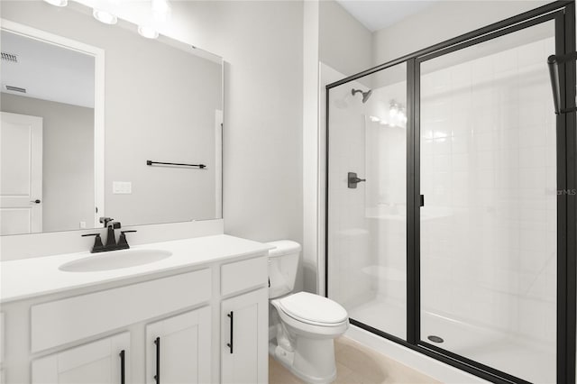 bathroom featuring vanity, a shower with door, and toilet