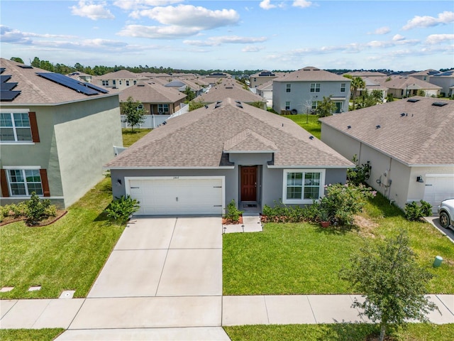 single story home featuring driveway, a residential view, an attached garage, a front lawn, and stucco siding