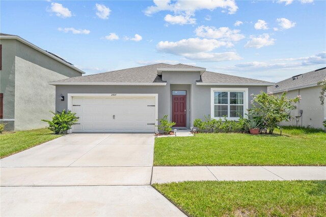 view of front of house featuring a front yard and a garage