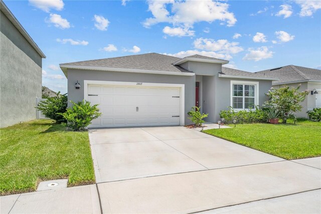 view of front of home featuring a garage and a front lawn