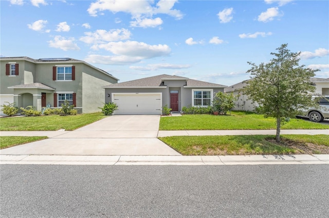 view of front of home featuring a garage and a front lawn