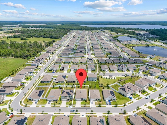 birds eye view of property featuring a water view and a residential view