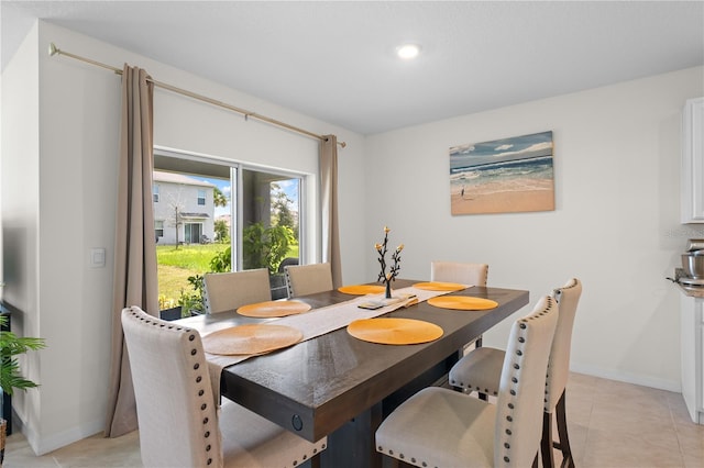 dining room featuring light tile patterned floors and baseboards