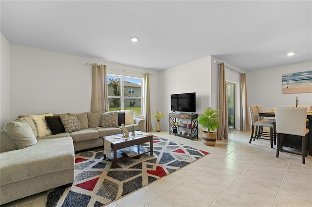 living room with recessed lighting, a textured ceiling, and tile patterned floors