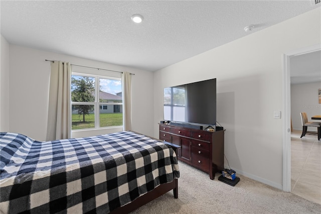 tiled bedroom featuring a textured ceiling