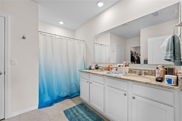 bathroom with tile patterned flooring and double vanity