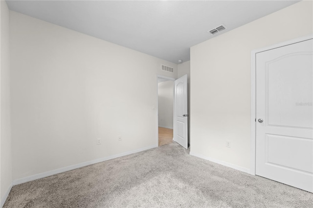 unfurnished bedroom featuring light colored carpet