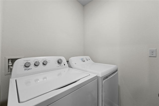 washroom featuring laundry area and washing machine and clothes dryer