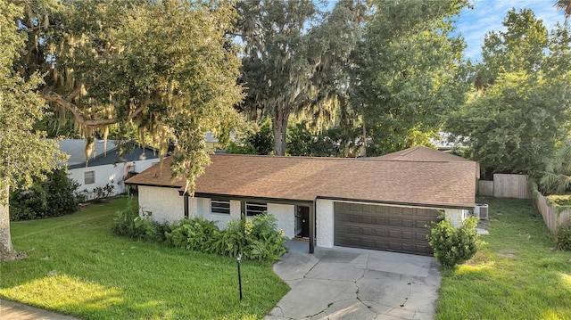 view of front of property with a garage and a front lawn