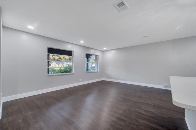 empty room with dark wood-type flooring