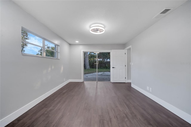 empty room with dark hardwood / wood-style floors