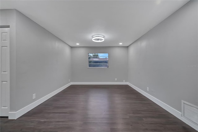 empty room featuring dark hardwood / wood-style flooring