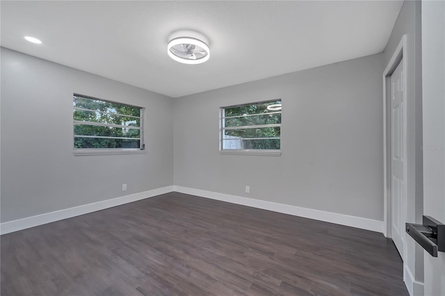 spare room featuring dark wood-type flooring